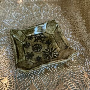 A square plate with a pattern of flowers on it.