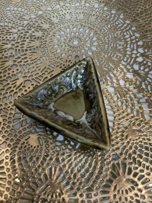 A triangle shaped bowl on top of a table.