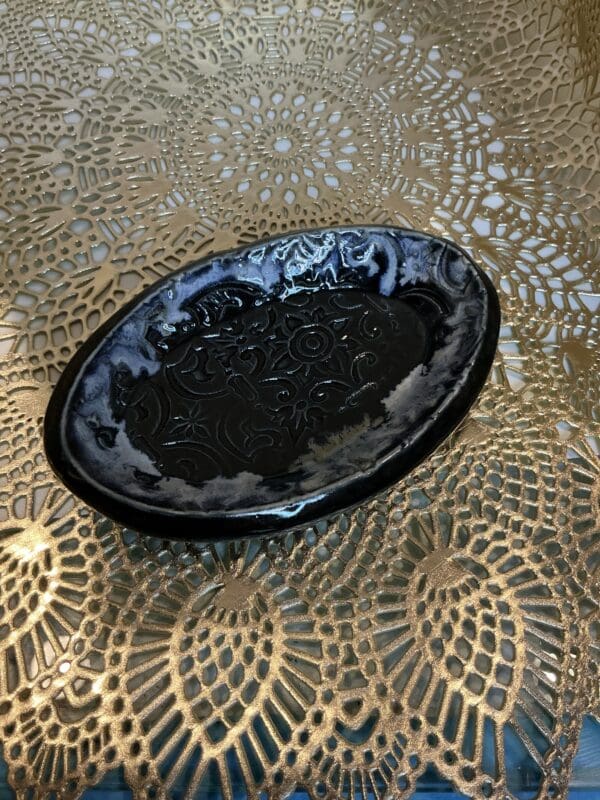 A black plate sitting on top of a table.