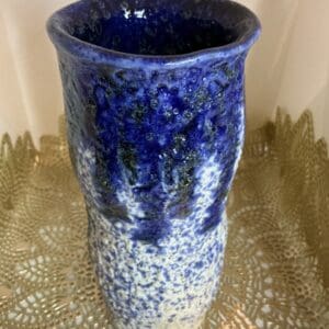 A blue vase sitting on top of a table.