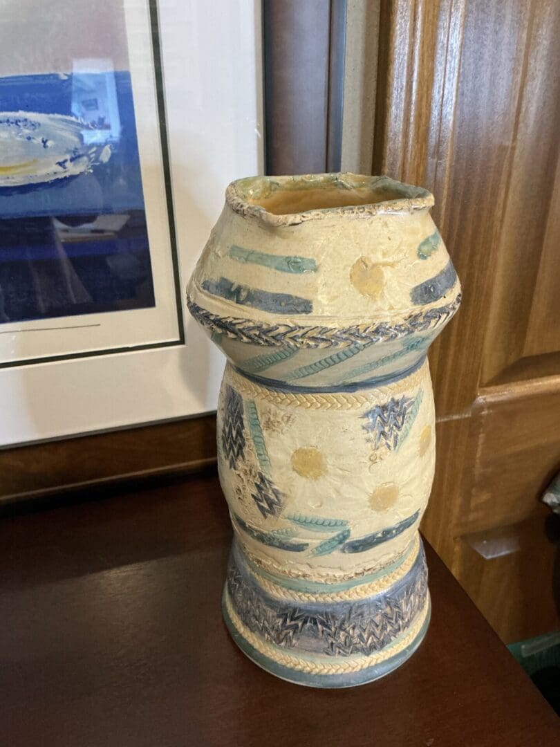 A vase sitting on top of a wooden table.