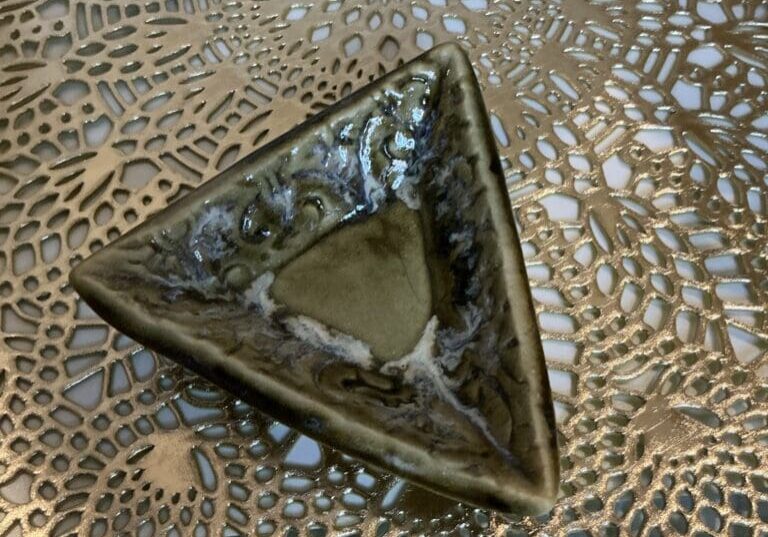 A triangle shaped bowl on top of a table.