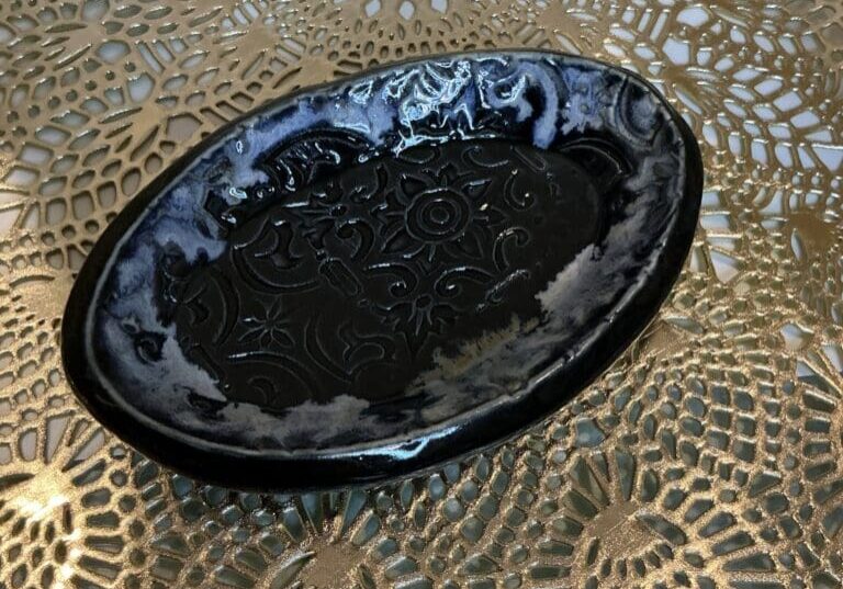 A black plate sitting on top of a table.